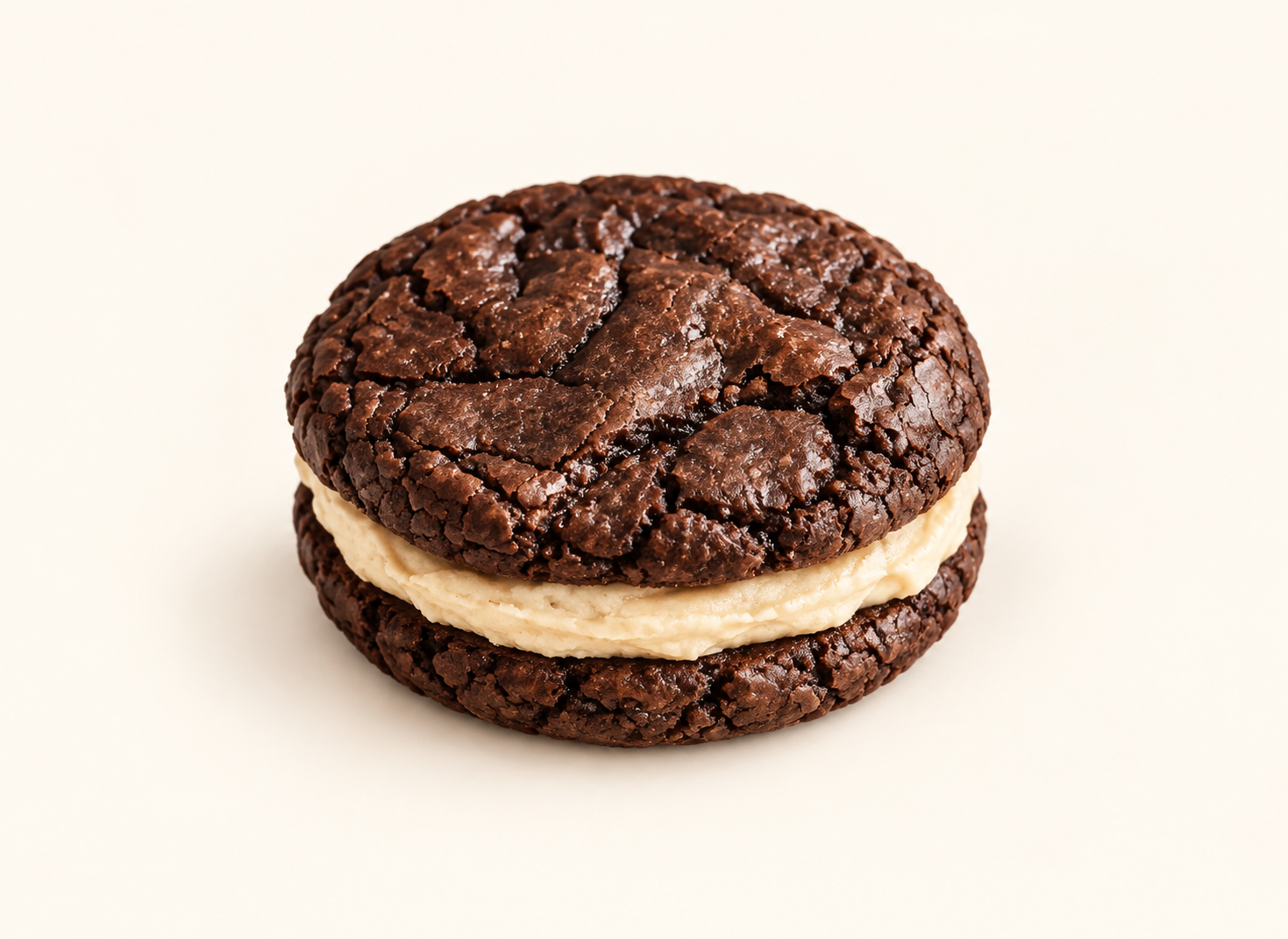 Brownie sandwich with two fudgy chocolate cookies and a soft cream filling on a cream background